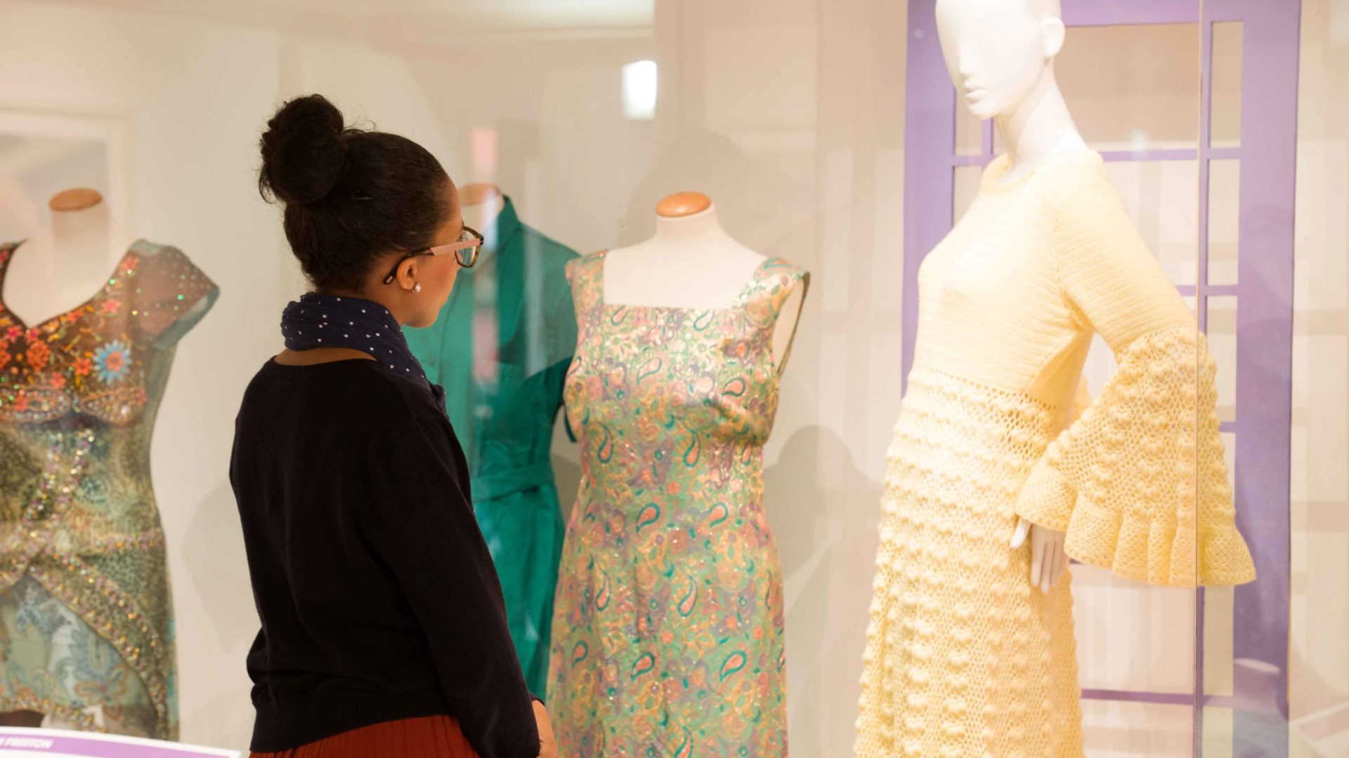 A visitor looks at some of the costumes on display at the Harris