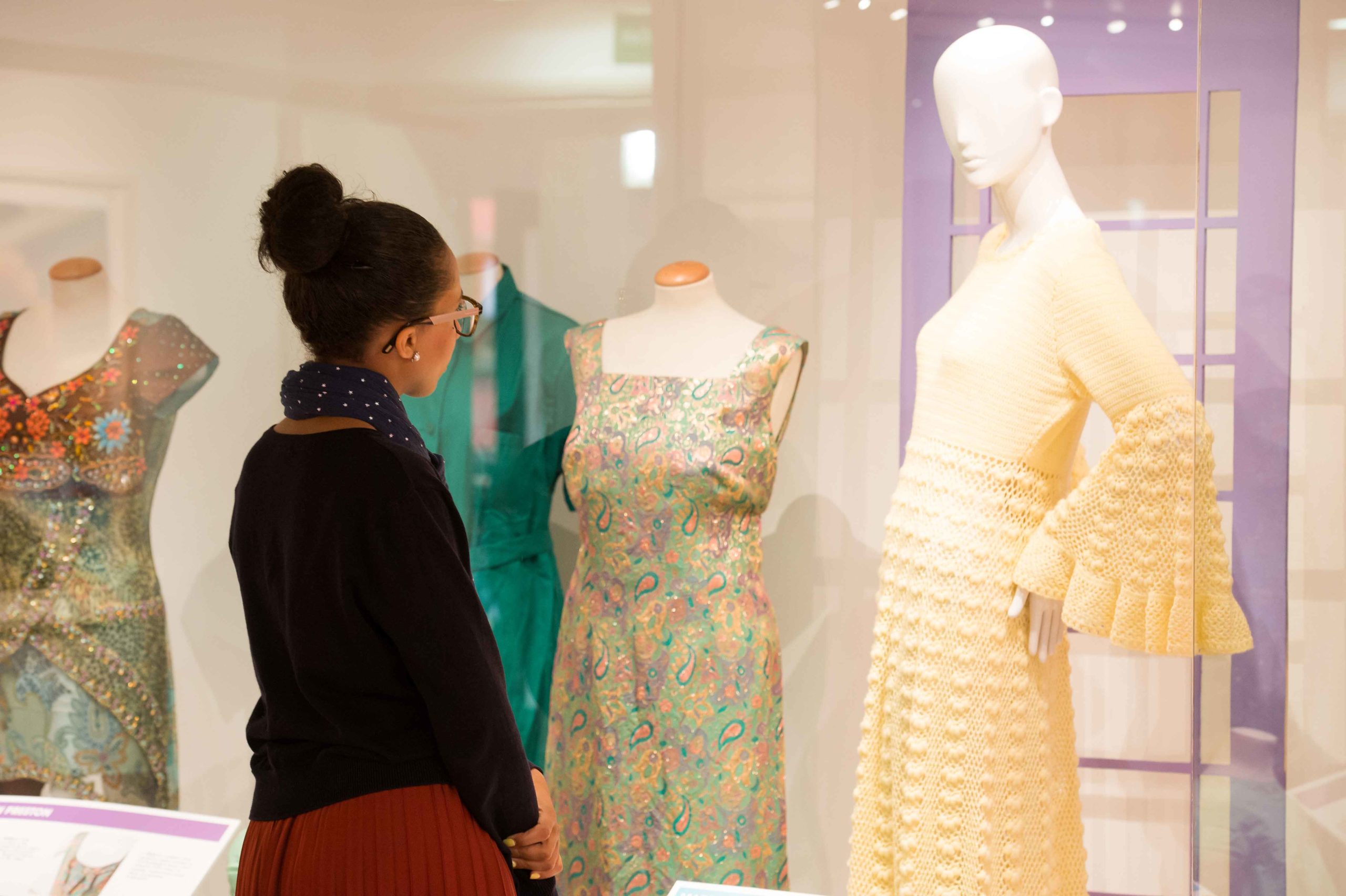 A visitor looks at some of the costumes on display at the Harris