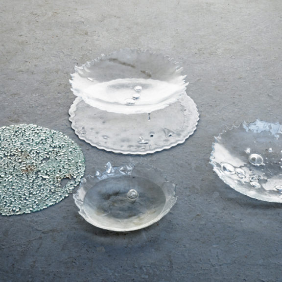 a series of glass bowls with imperfections in them caused by the riots