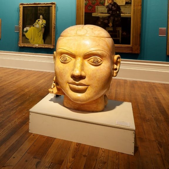 Image shows ladies head made of plaster. The head is large and is places in the centre of the Harris' art gallery.