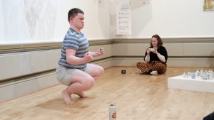 Man crouching down as a part of a perfomance