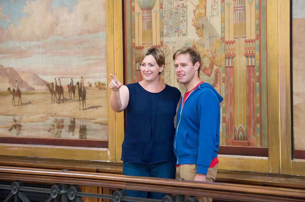 A couple visiting the Egyptian Balcony at the top of the Harris building