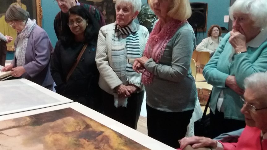 image of friends of the harris stood looking at detailed painting