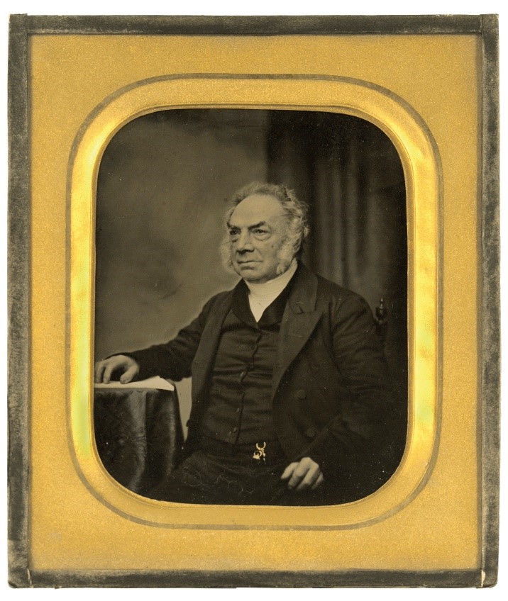 Man in old ambrotype. Ambrotype is in gold frame. 