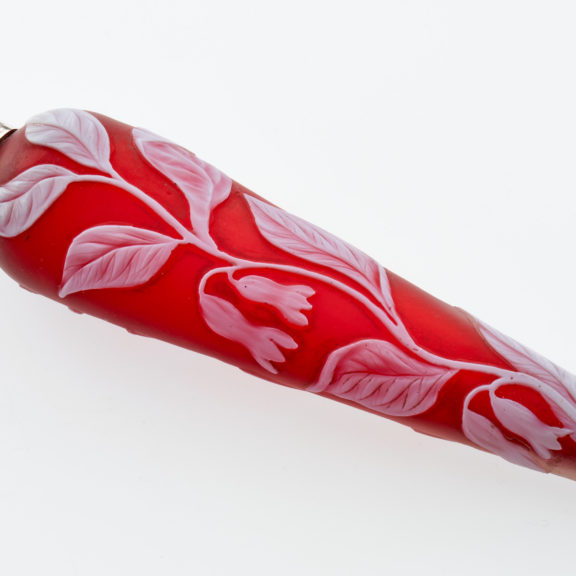 Red cameo glass scent bottle with white leaf decorative detail