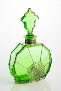 Green toilet water scent bottle with decorative metalwork in spiders web design