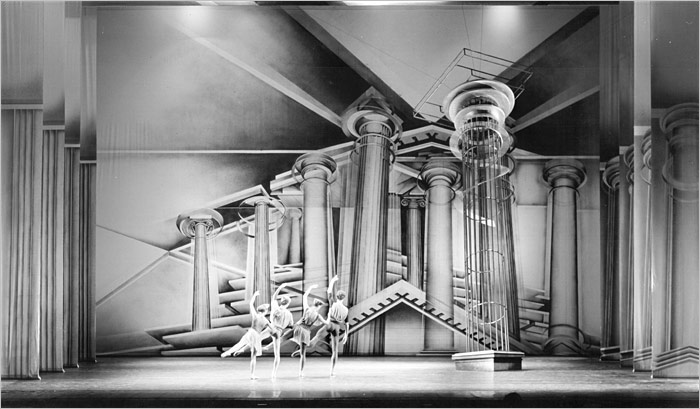 4 ballet dancers dancing in front of pillars on a theatre stage