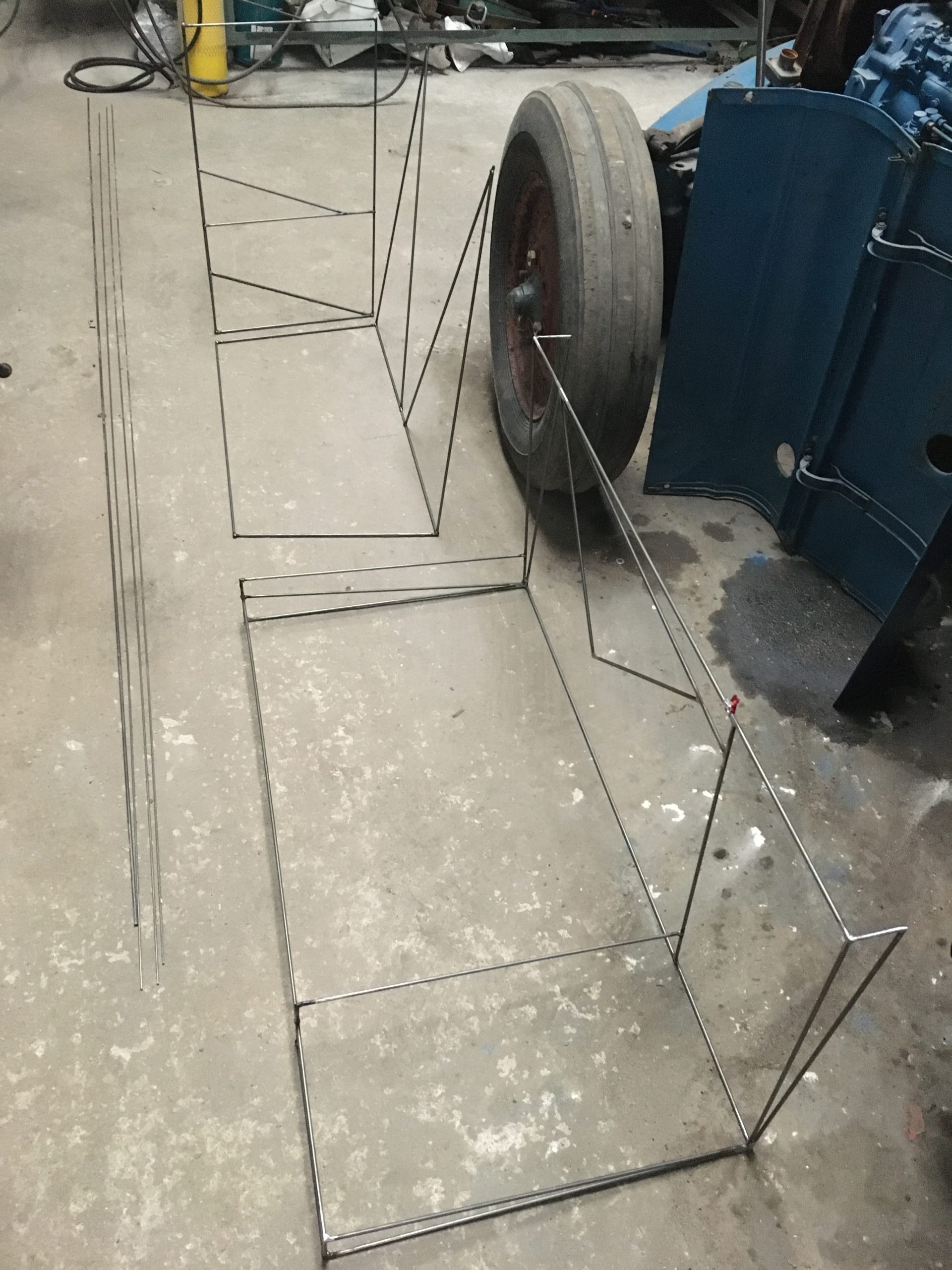 welded metal frames on floor in workshop
