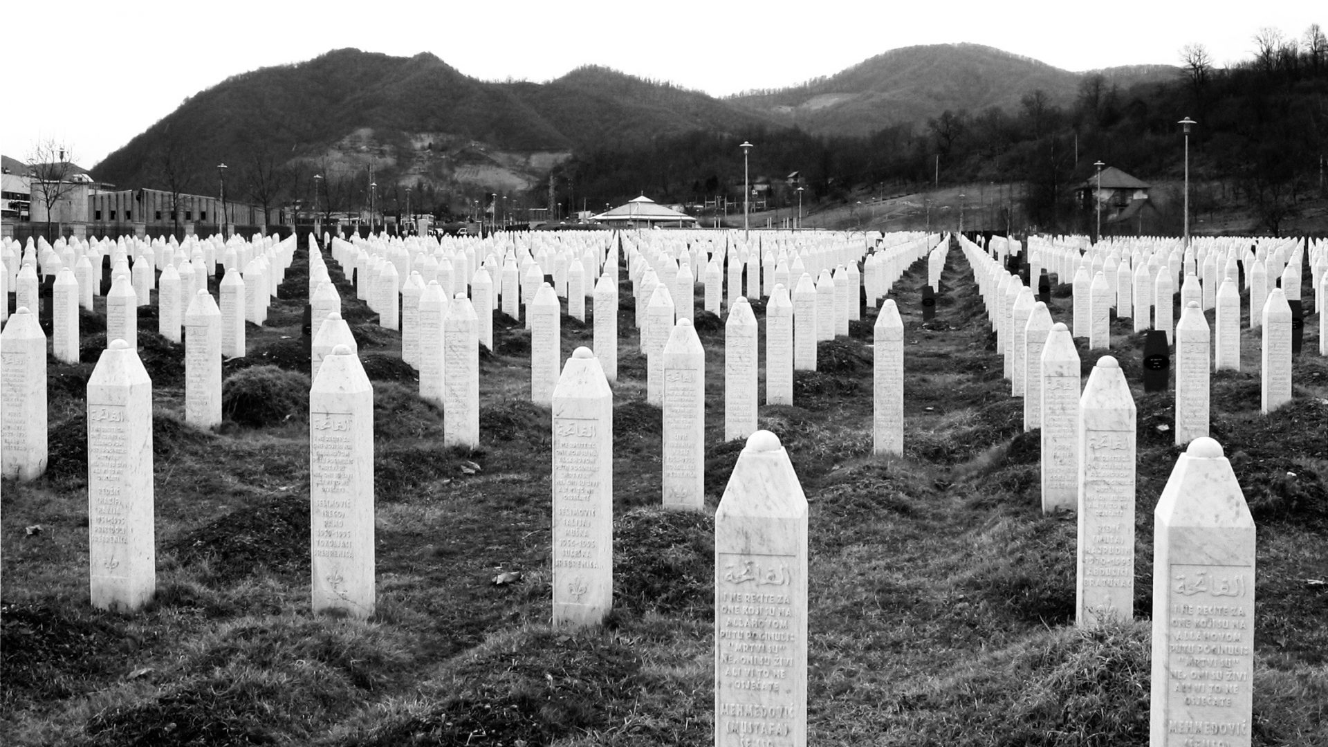 A field of white tomb stones representing those that dies in the massacre.