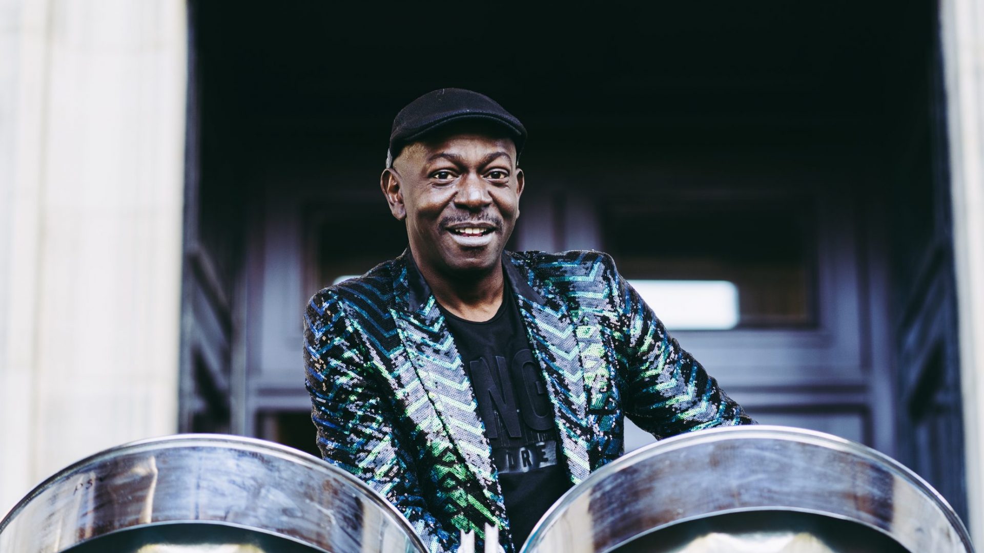 Dave with steel pans outside the Harris