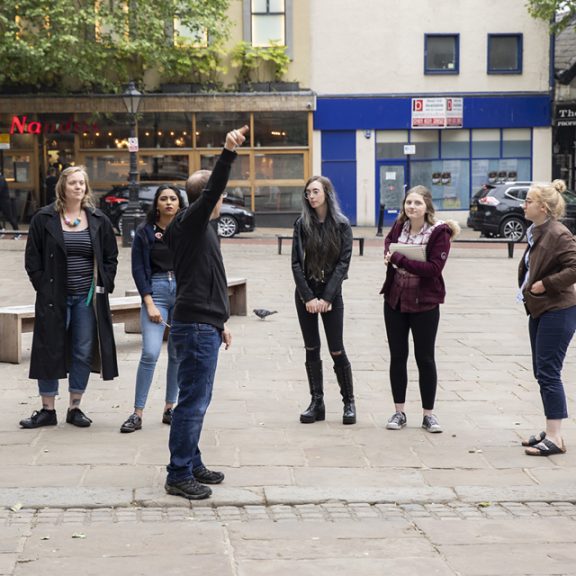 Young people stood looking at building