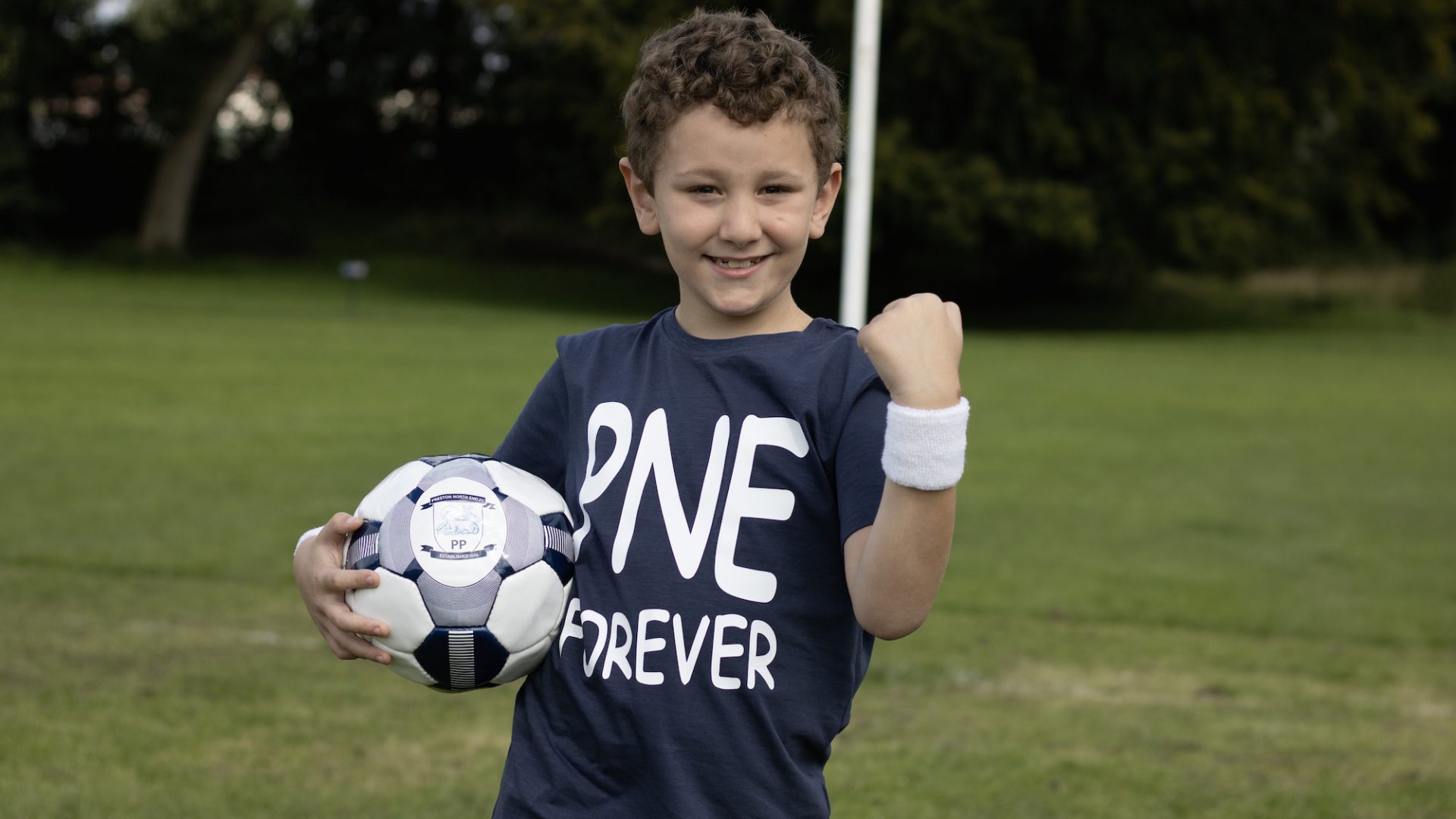 Little boy with a football and PNE shirt