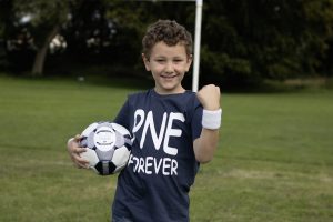 Little boy with a football and PNE shirt