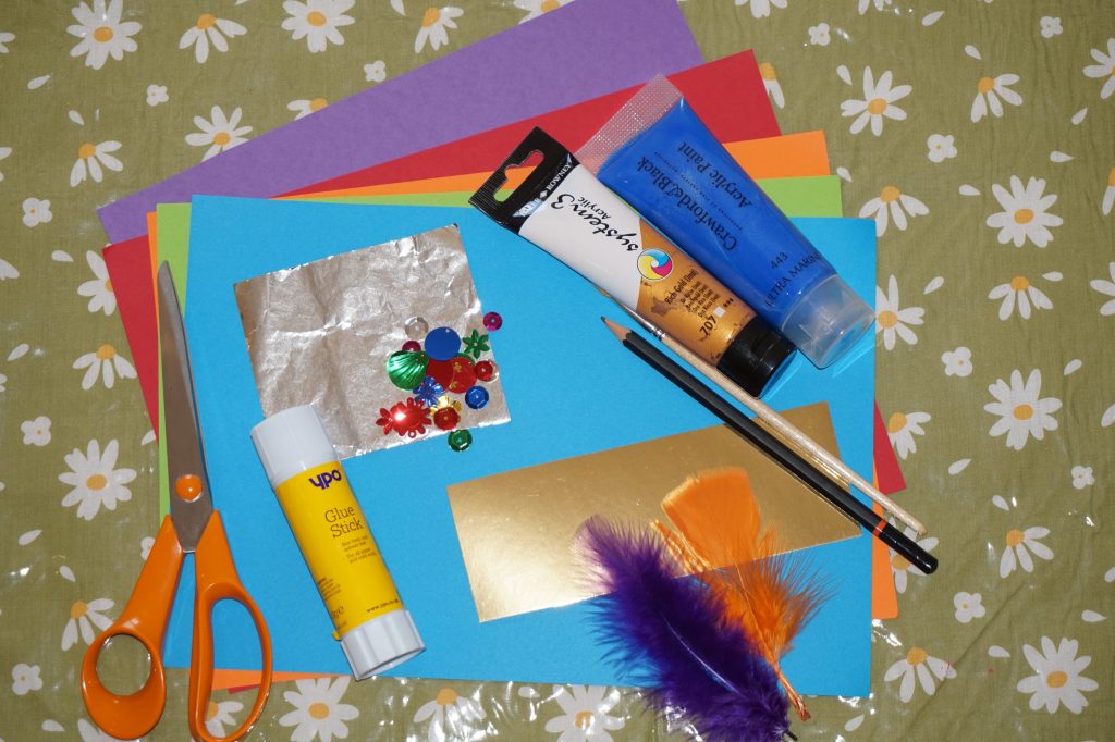 Craft items, coloured card, paint, paint brush, pencil, scissors, glue, and tin foil