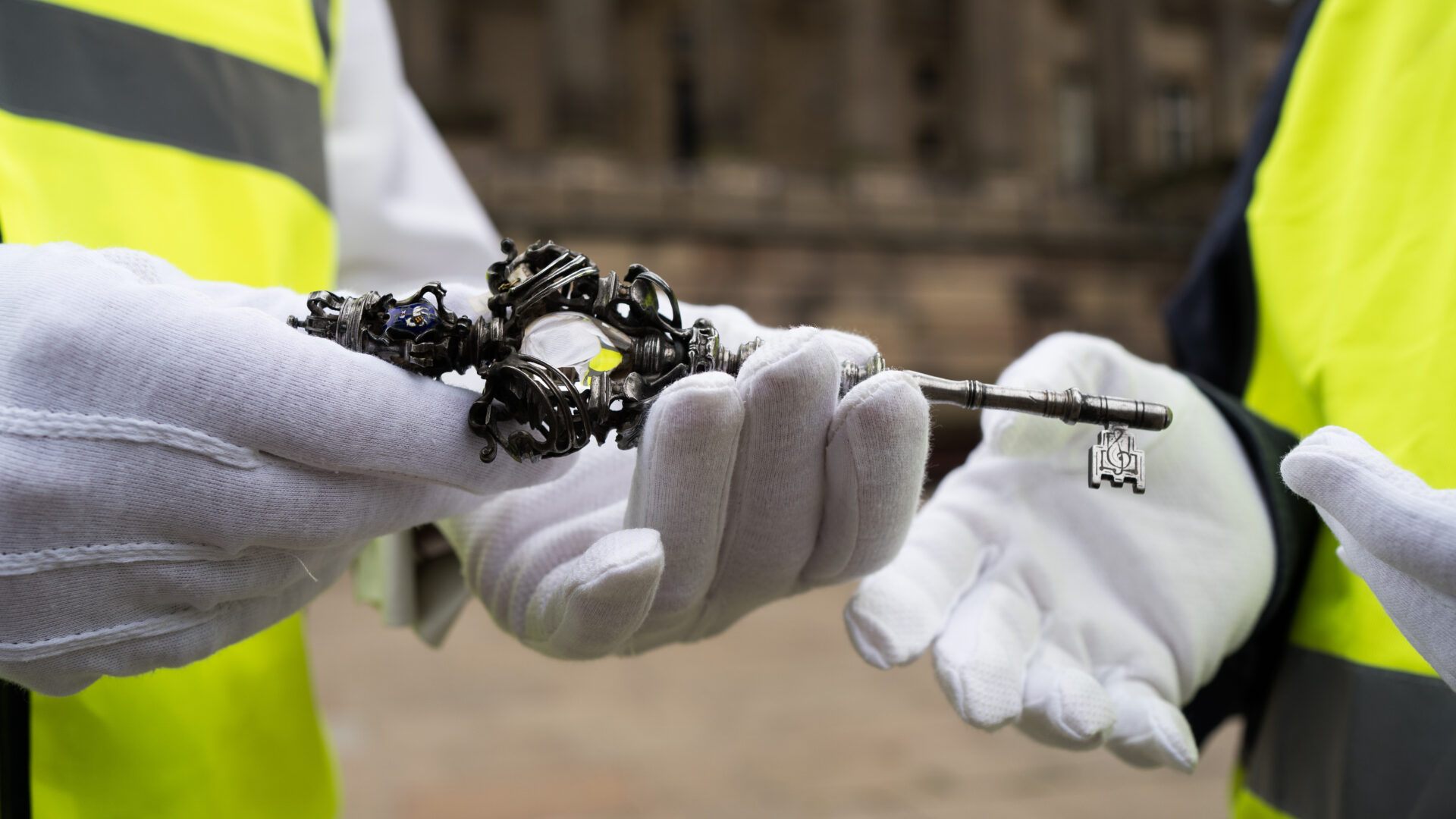 Image of Councillor Peter Kelly handing over the ceremonial Harris key to Michael Conlon outside the front of the Harris building.