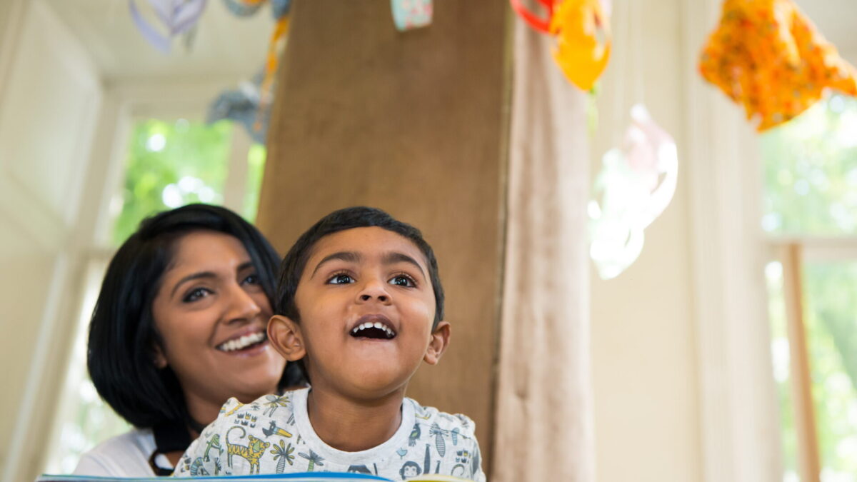 Image of a mother and son looking at a hanging mobile in the Children's Area