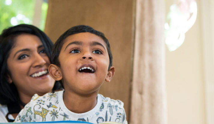 Image of a mother and son looking at a hanging mobile in the Children's Area