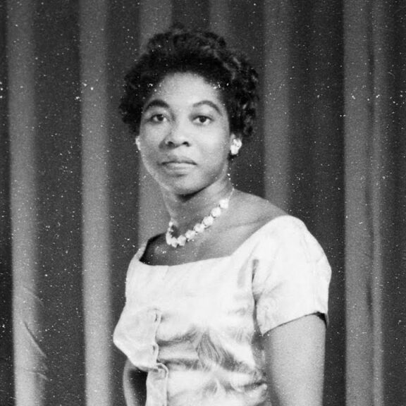 Image of Maxine Grant wearing a dress with pearls