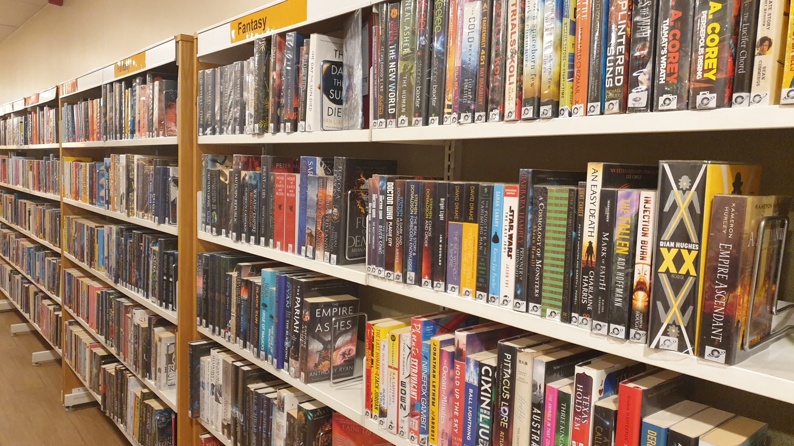 Image of library books on a white shelf 