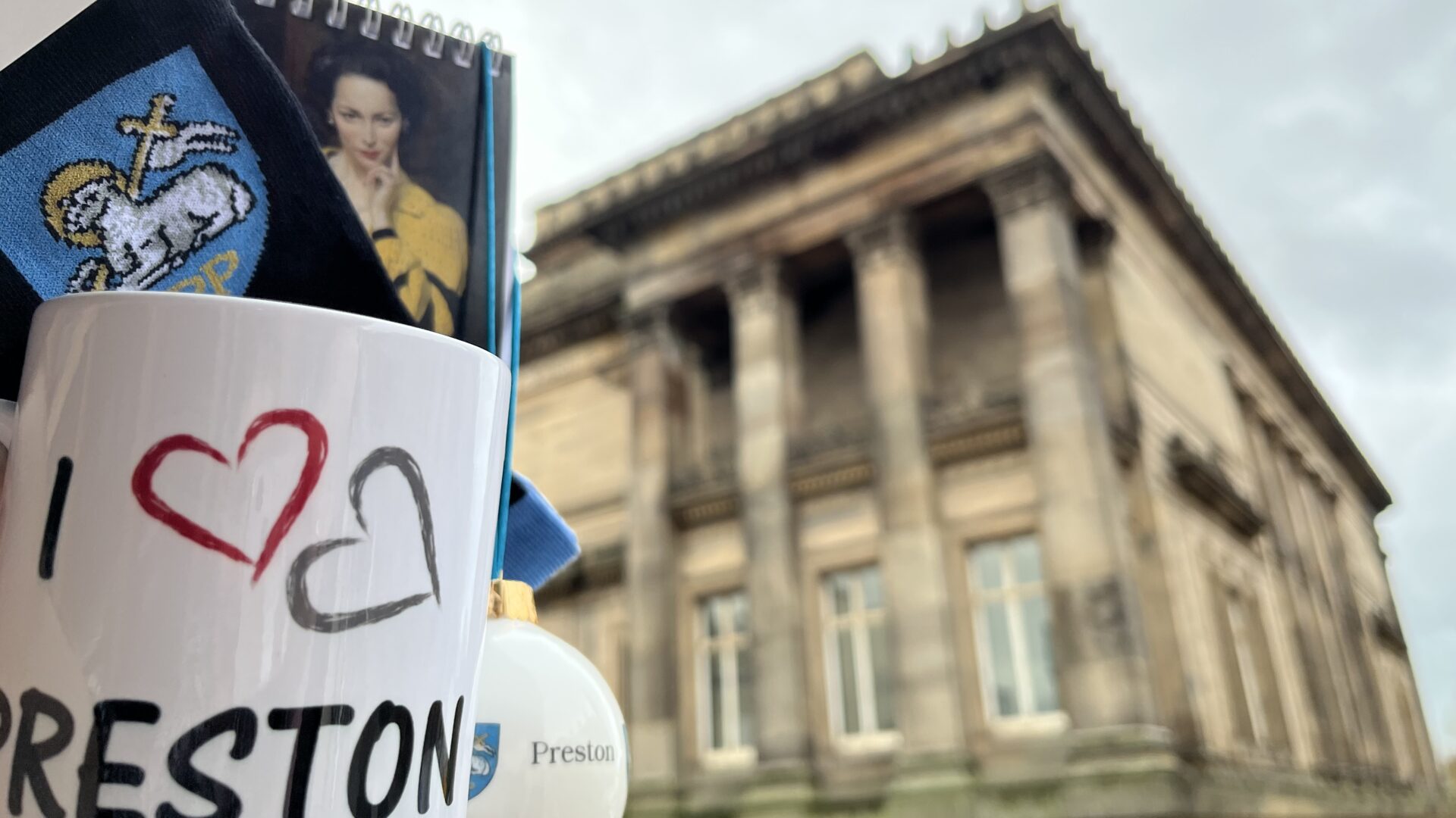 Image taken outside the Harris with general shop merchandise of a mug, socks and a bauble.