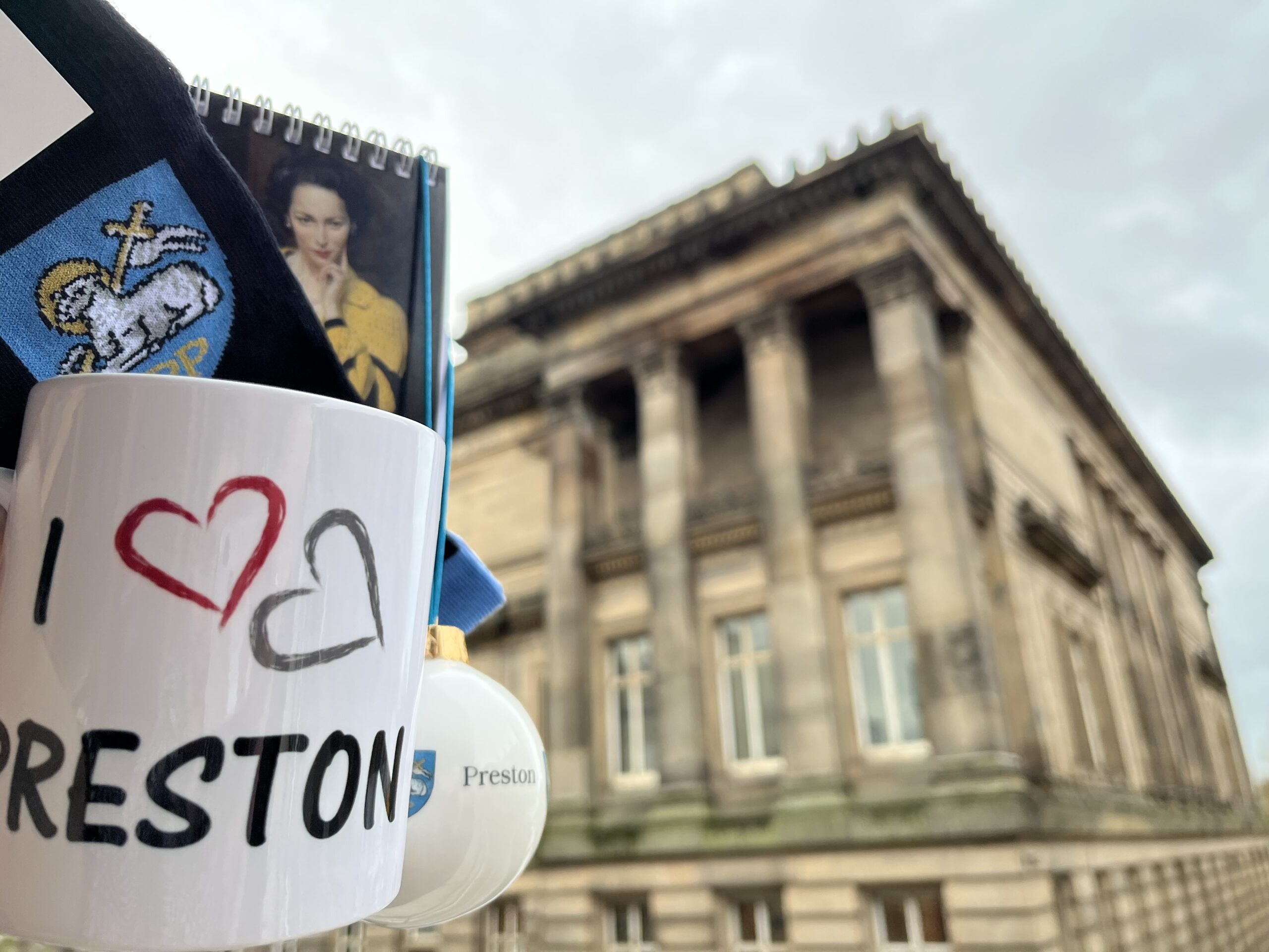 Image taken outside the Harris with general shop merchandise of a mug, socks and a bauble.