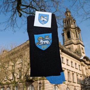 Black and blue Preston socks in front of sessions house.