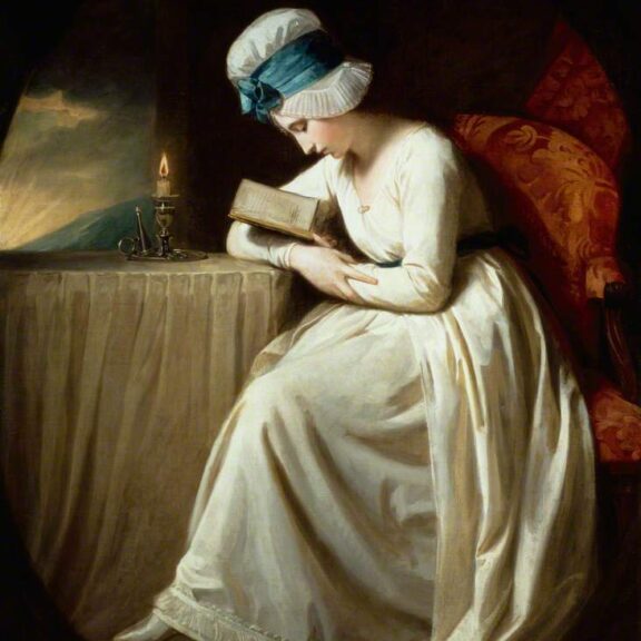 Image of a lady reading by candlelight.