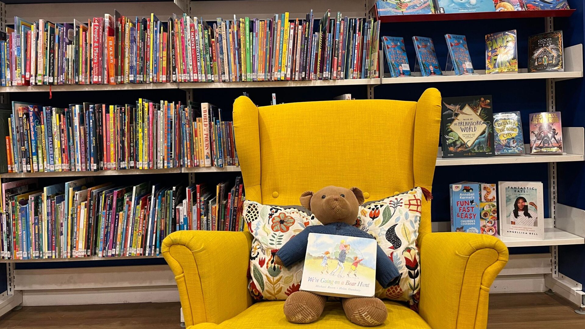 Image of a bear on a yellow chair in the children's library,