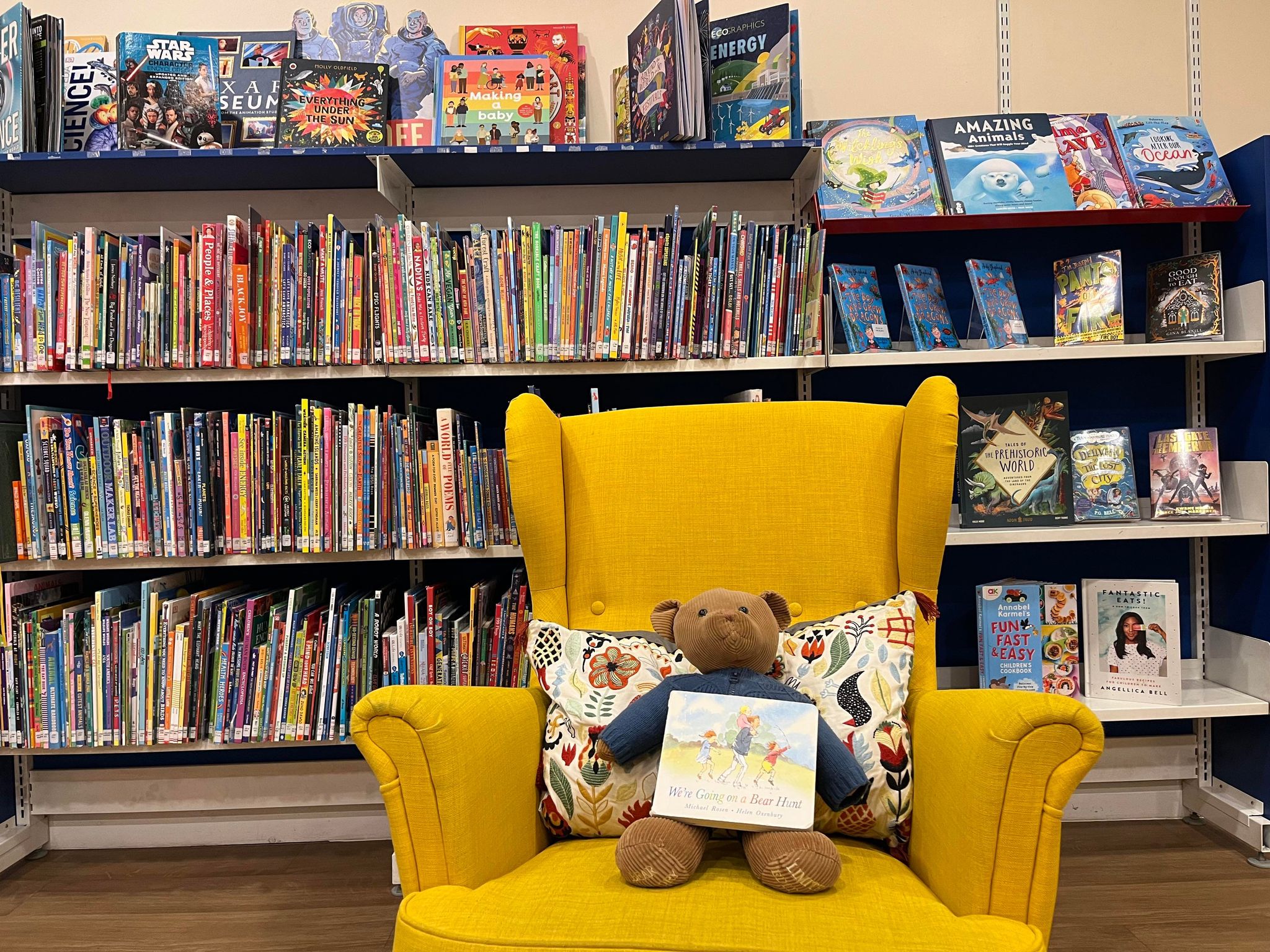 Image of a bear on a yellow chair in the children's library,