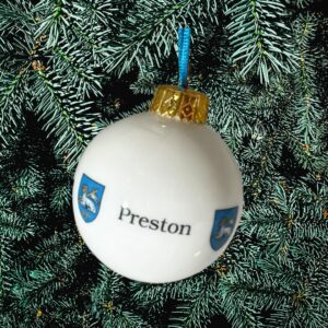 A white ceramic bauble decorated with the Preston crest.