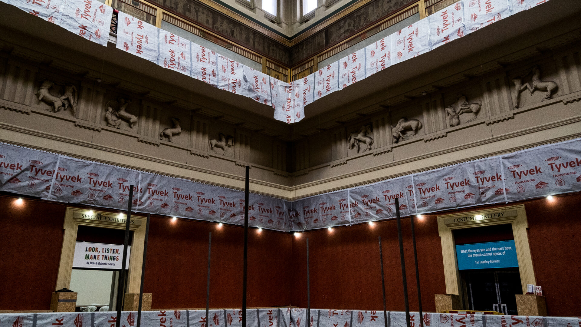 Image of the first floor of the Harris with Tyvek bags draped over the balcony