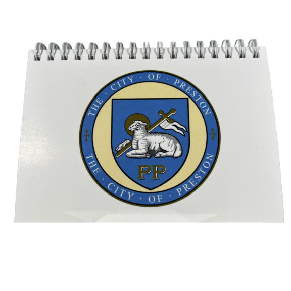 Image of a white notepad with the Preston Crest stamped on it.