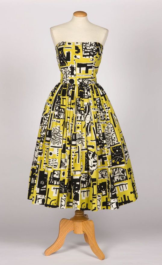 Image of a yellow and black printed strapless dress