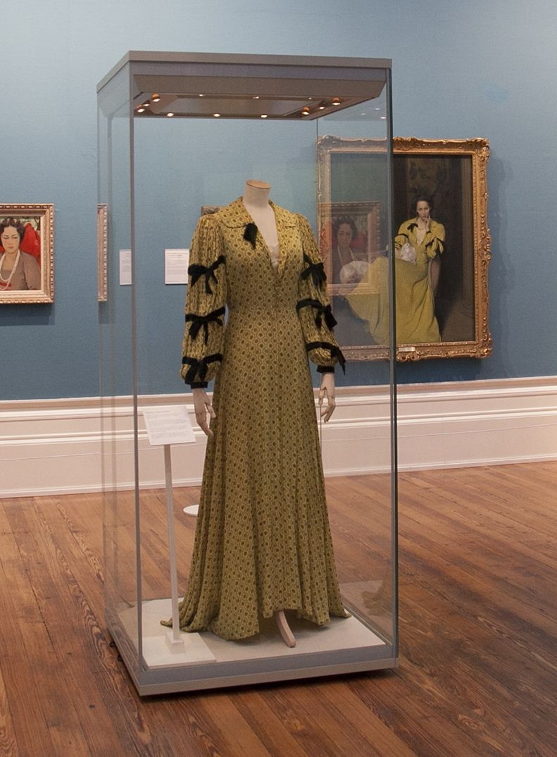 Image of a yellow dress behind glass