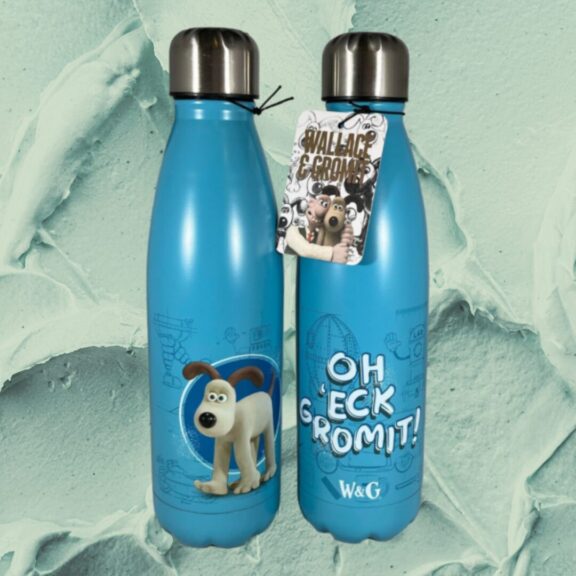 A blue gromit flask with green clay in the background.