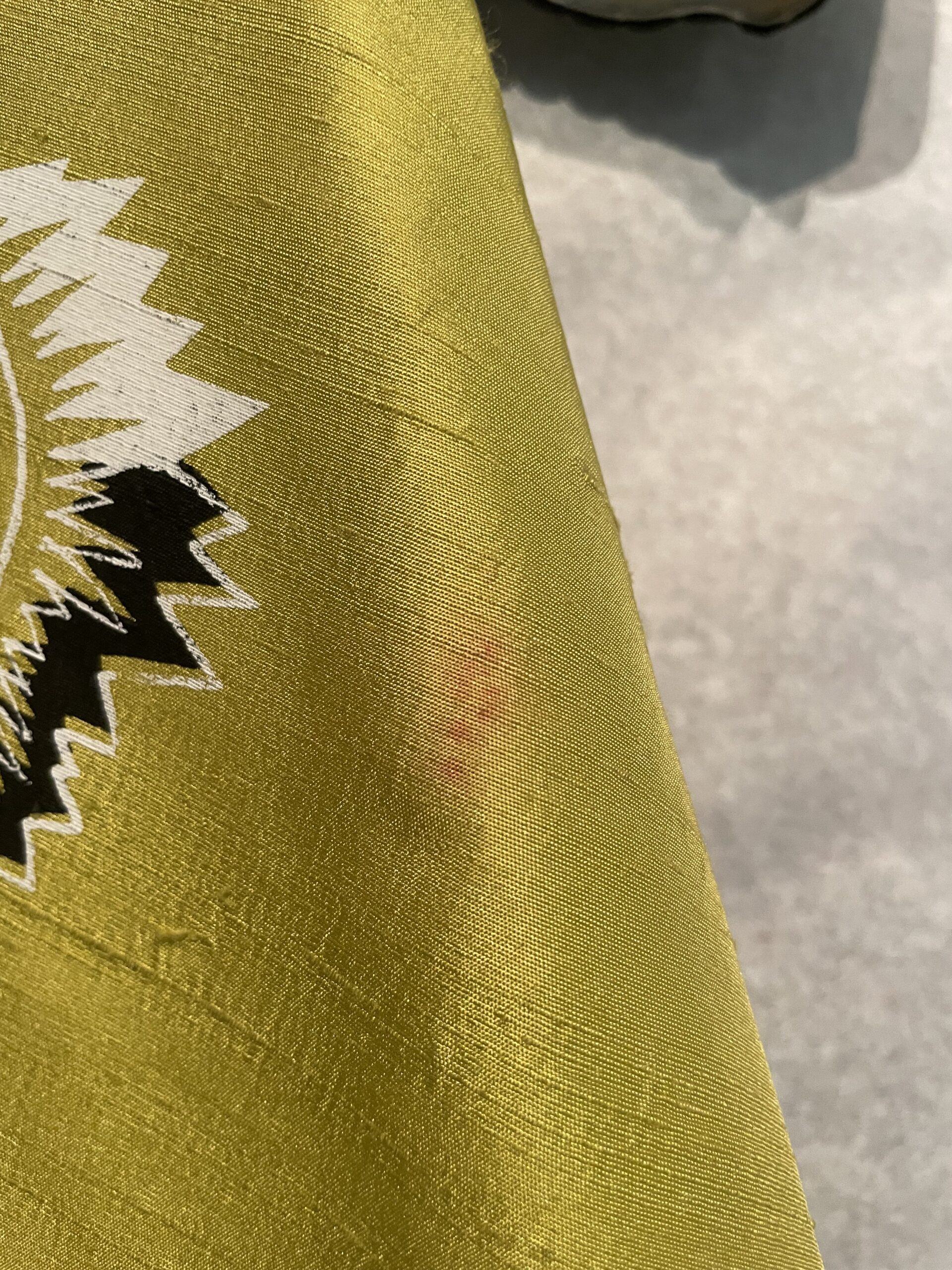 Signs of makeup on yellow fabric