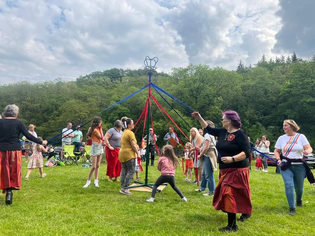 Image of people dancing round the maypole