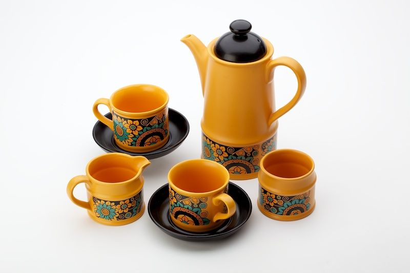 Image of an orange and black teapot and four cups