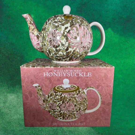 A teapot with a honeysuckle design on a painted green background.
