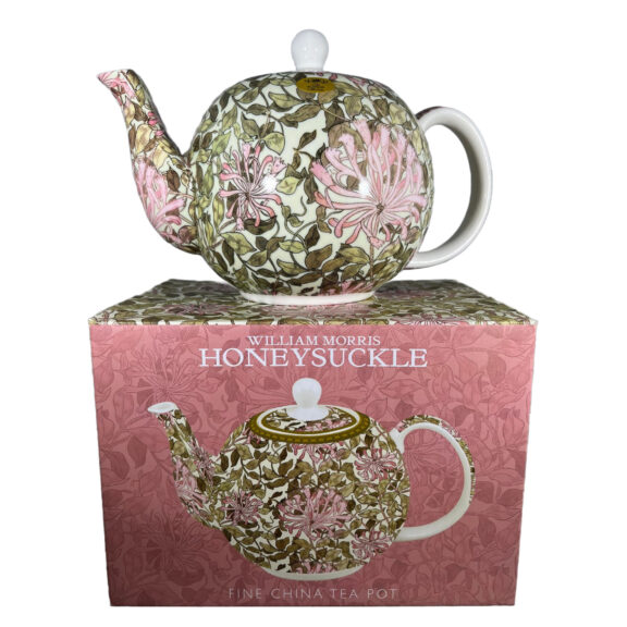 Image of a teapot on top of it's cardboard box with a floral design in pink.
