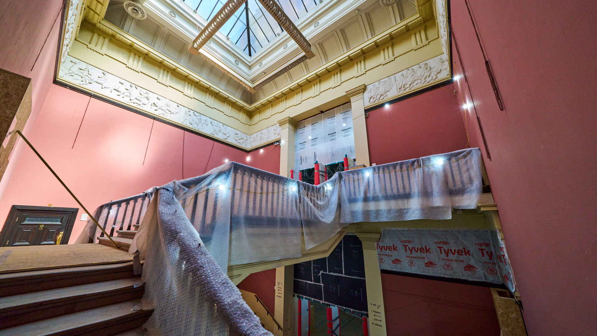 An image of a stairway and bannister covered in bubble wrap.