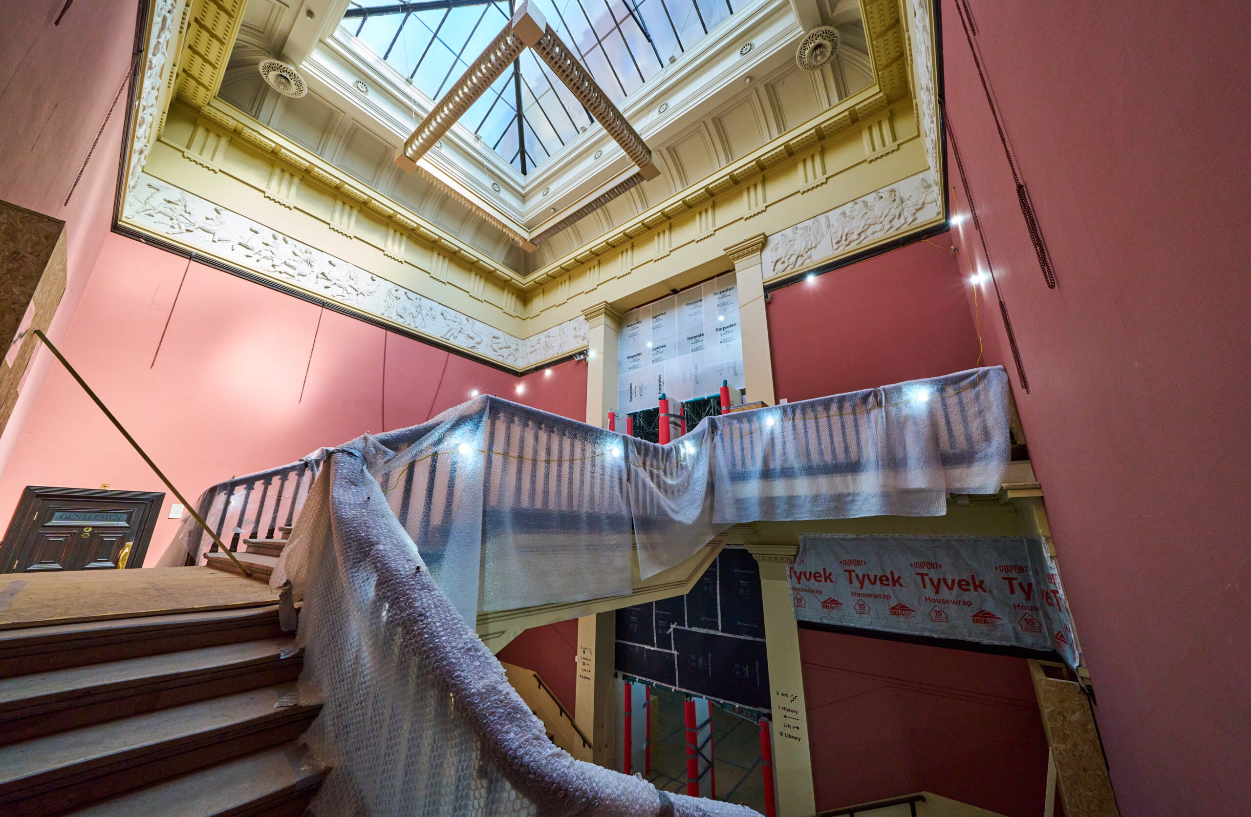 An image of a stairway and bannister covered in bubble wrap.