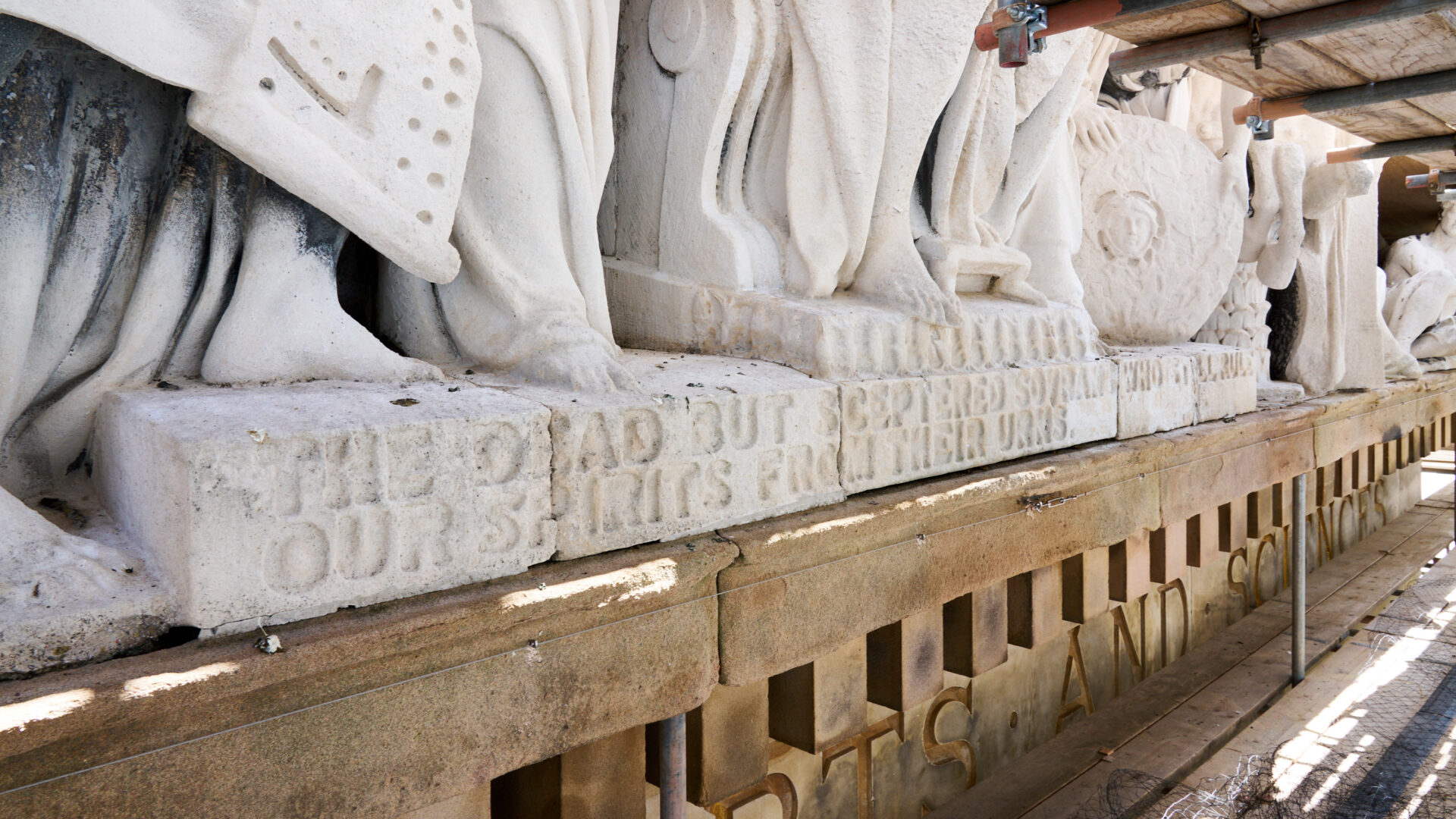 An image of engraved text on the pediment.