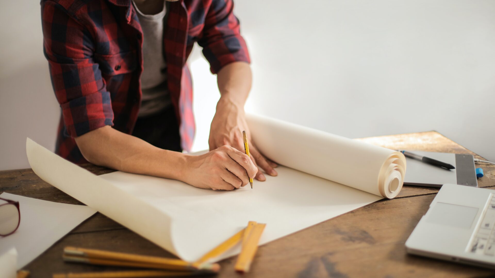 A person sketches on a large piece of paper.