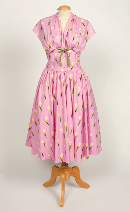 Image of a baby pink sleeveless dress on a mannequin