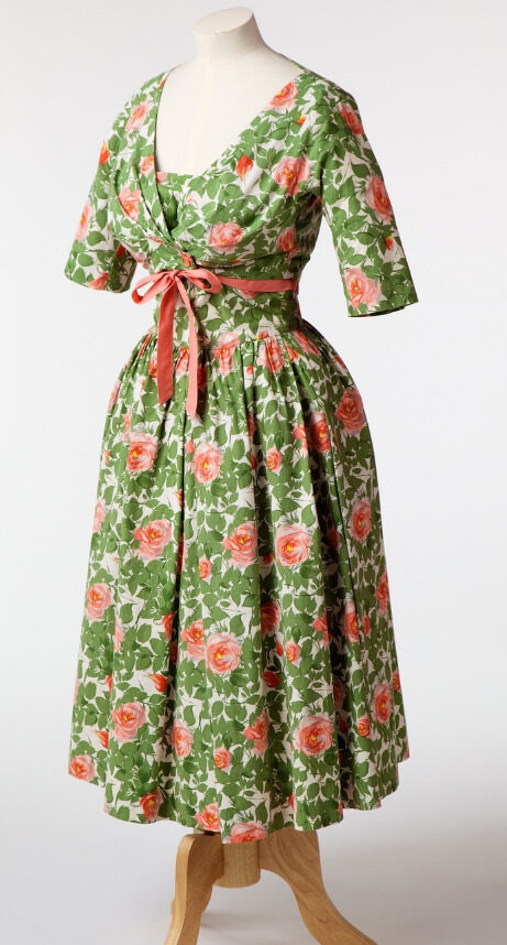Green and pink flower patterned dress with 1/4 length sleeves and a pink bow detail