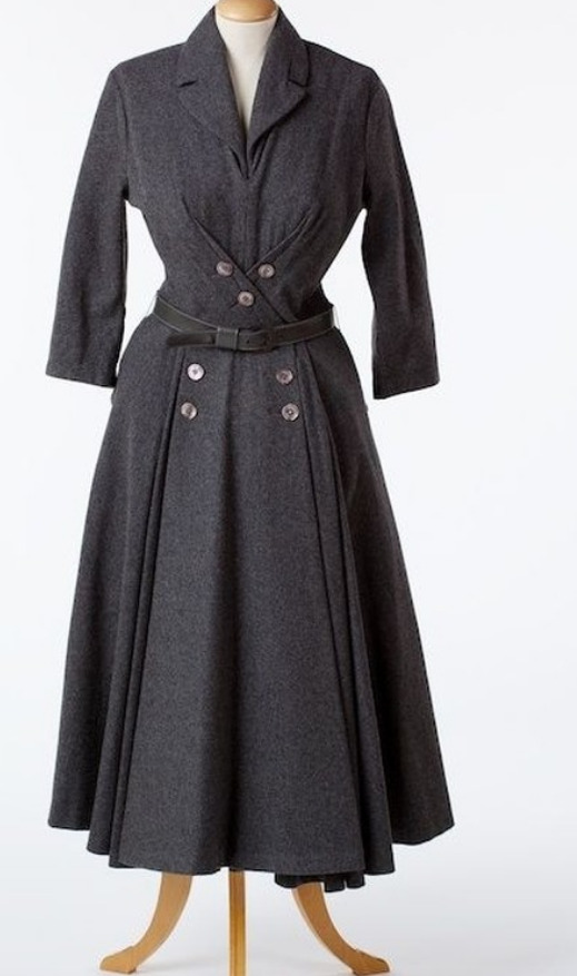 Long sleeved black coat with grey button details