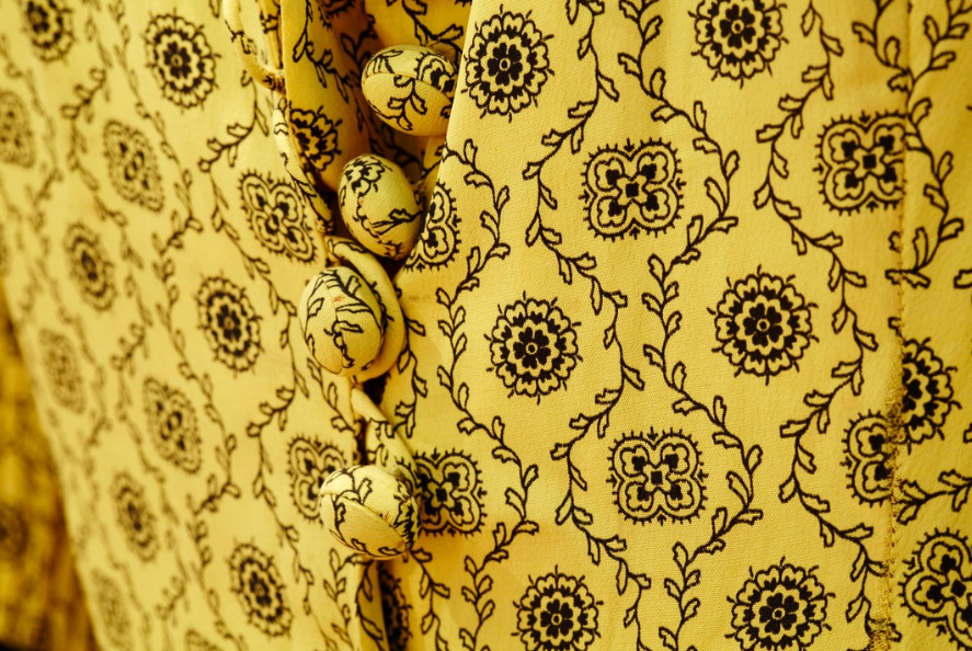 Close up image of a yellow and black patterned fabric