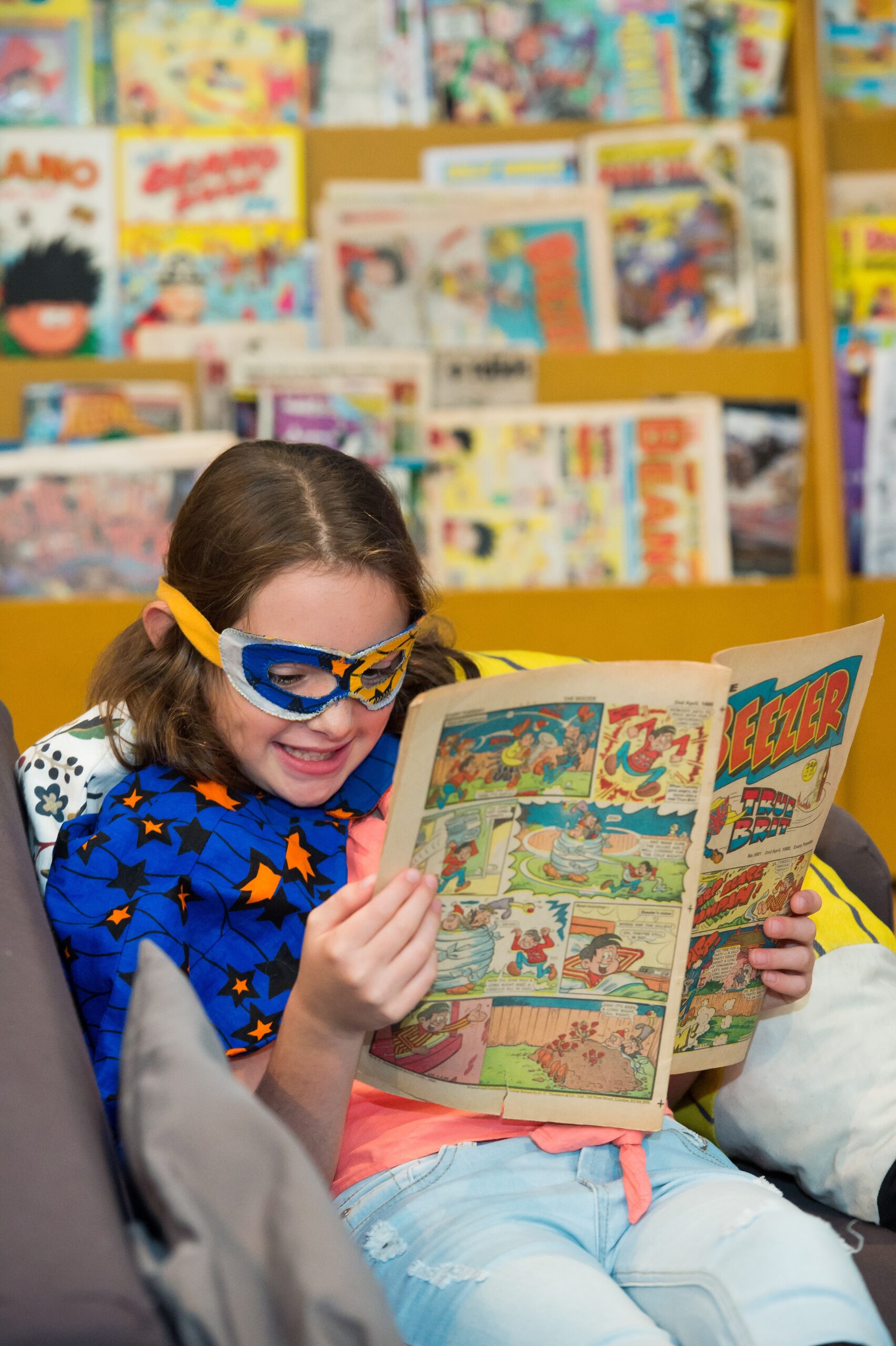 Image of a child reading a comic book.