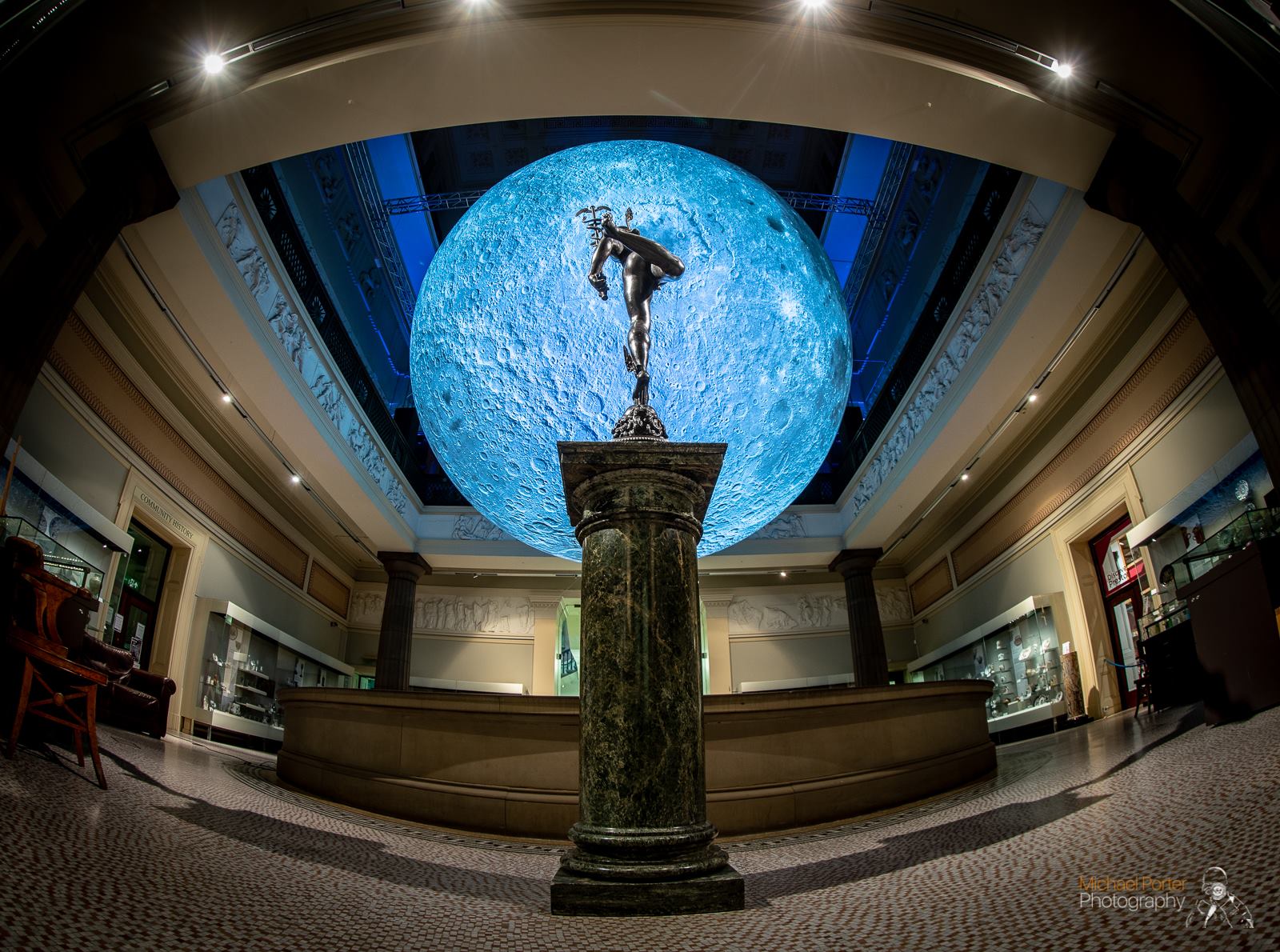 A large moon hangs suspended in the Harris' rotunda space.